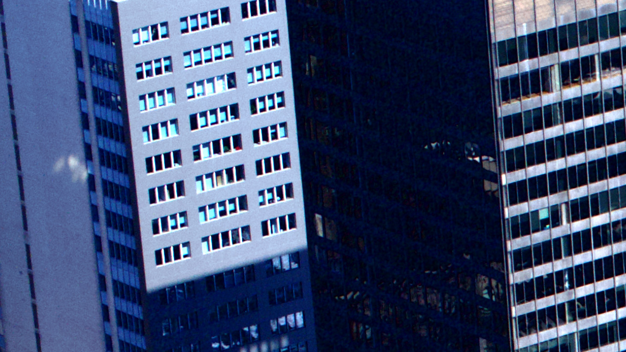 A recovered-shadow crop from a Sony RAW before noise reduction: heavy luminance speckle and red and green color blotches across the dark tones.